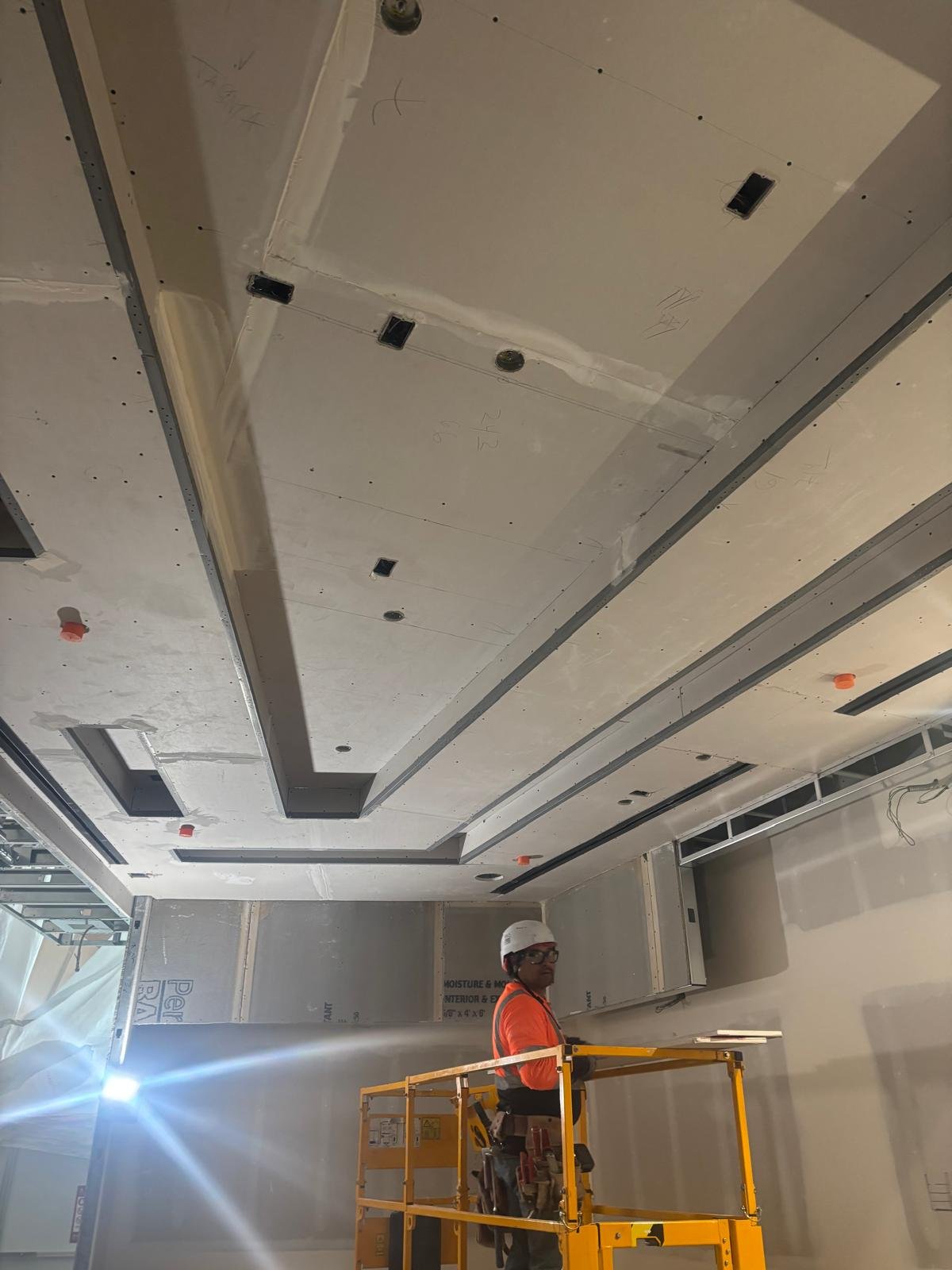Drywall taped joints and ceiling detail during interior construction